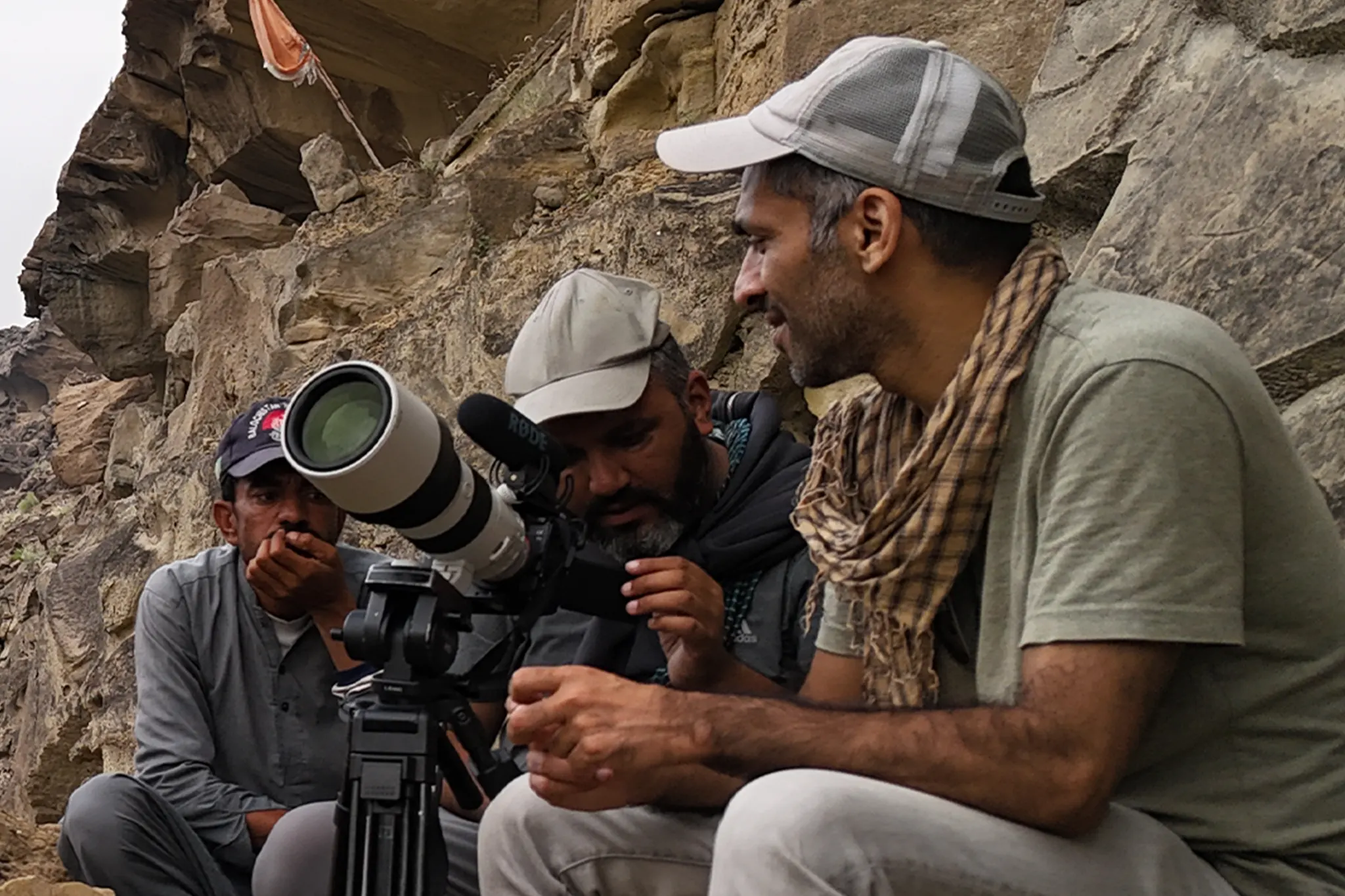 Field team documenting a conservation site in rocky terrain